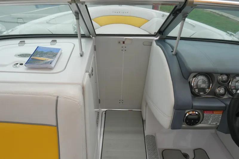 Slide: The Image of 2007 Correct Craft 236 Team Edition boat interior with dashboard and seating. - 23