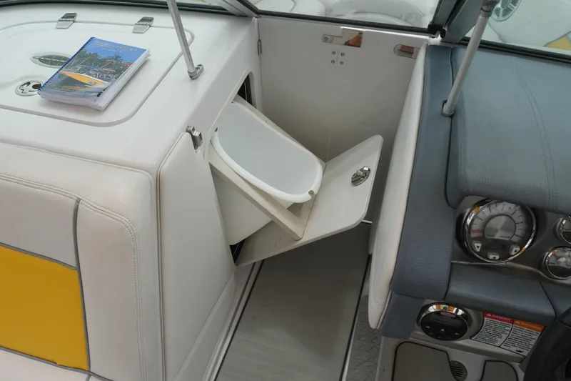Slide: The Image of 2007 Correct Craft 236 Team Edition boat interior with storage compartment and dashboard. - 24