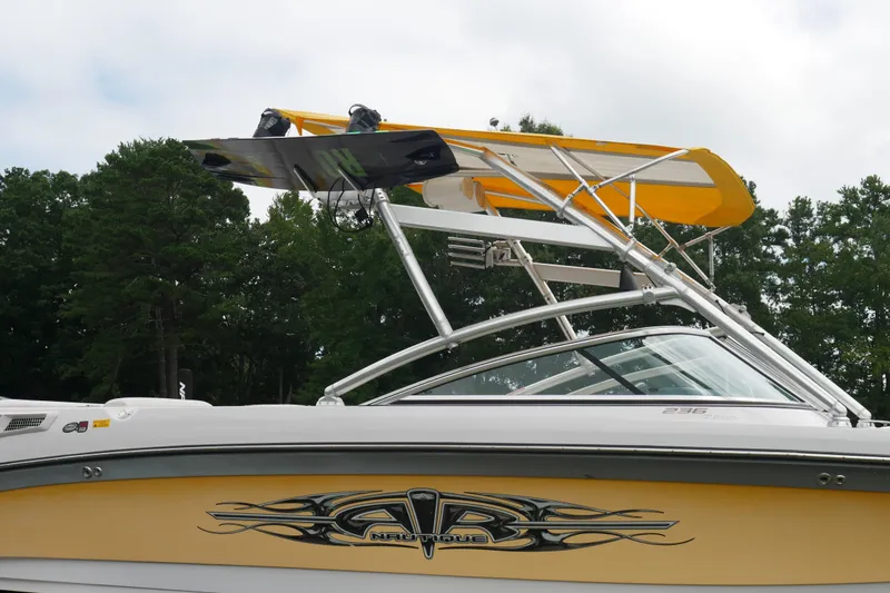 Slide: The Image of 2007 Correct Craft 236 Team Edition boat with wakeboard tower, yellow accents, and sleek design. - 31