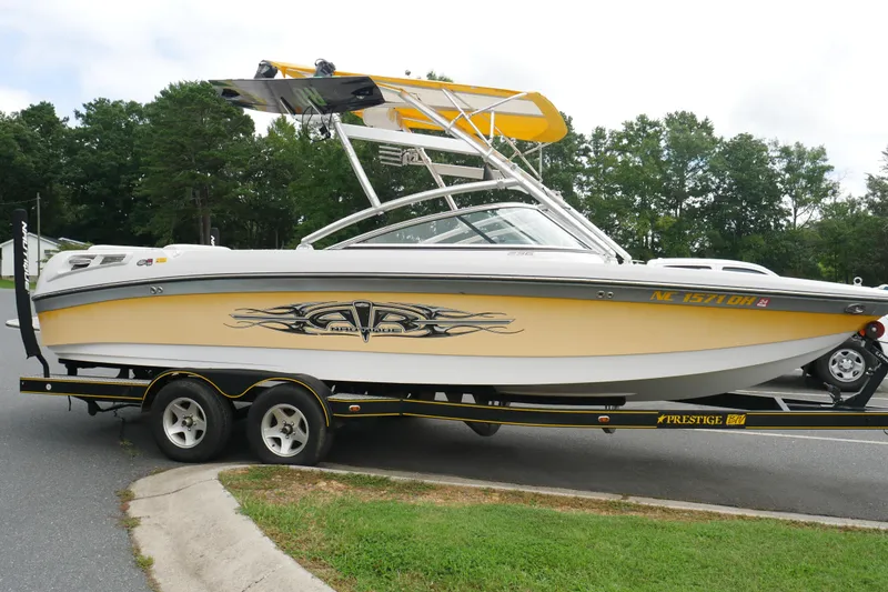 Slide: The Image of 2007 Correct Craft 236 Team Edition boat on trailer, parked on a road. - 4
