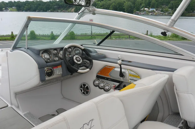 Slide: The Image of 2007 Correct Craft 236 Team Edition boat interior with steering wheel and dashboard controls. - 9