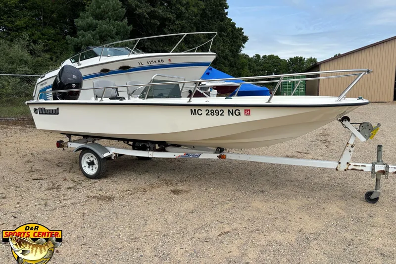 Slide: The Image of 1986 Wahoo 16.2 boat with Suzuki outboard motor in a parking lot. - 4