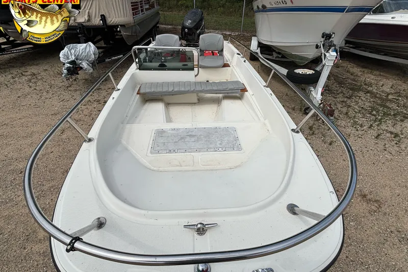 Slide: The Image of 1986 Wahoo 16.2 boat on trailer, parked outdoors, with visible seating and steering console. - 6