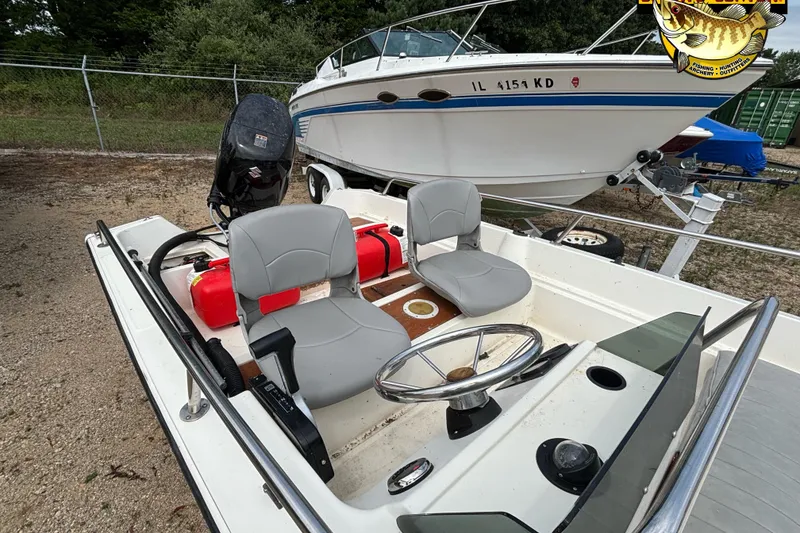 Slide: The Image of 1986 Wahoo 16.2 boat with dual seats and steering wheel, parked outdoors. - 7