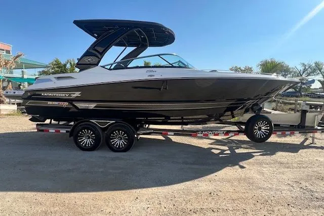 The Image of 2022 MONTERY 298 boat on trailer, sleek design, sunny day, outdoor setting. - 1
