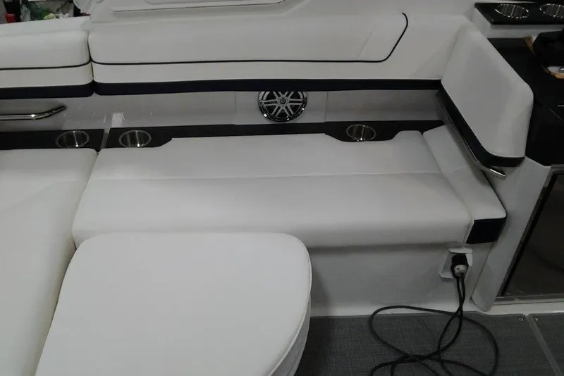 Slide: The Image of 2016 Formula 330 Crossover Bowrider interior with open door and seating area. - 10