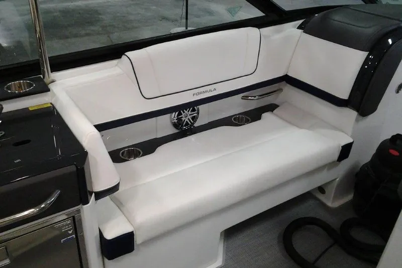 Slide: The Image of 2016 Formula 330 Crossover Bowrider interior with white seating and speaker system. - 12