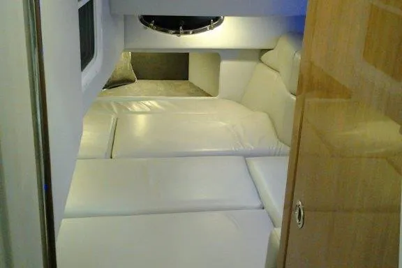 Slide: The Image of 2016 Formula 330 Crossover Bowrider on trailer, showcasing spacious seating and sleek design. - 18