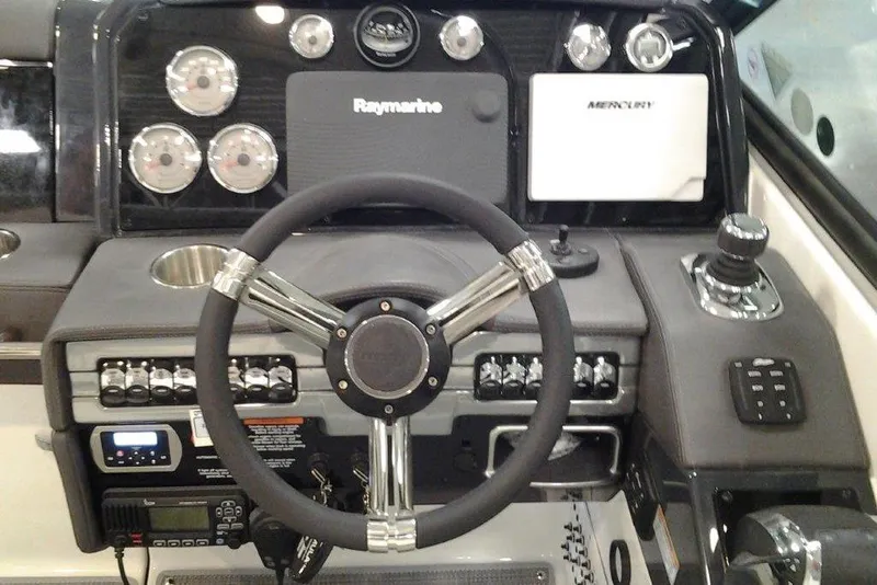 Slide: The Image of 2016 Formula 330 Crossover Bowrider boat with spacious deck and seating, docked outdoors. - 24