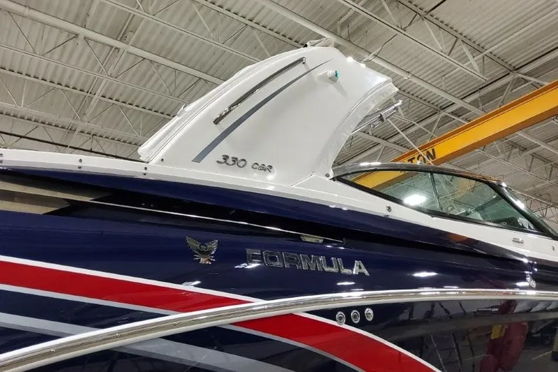 Slide: The Image of 2016 Formula 330 Crossover Bowrider interior with white seating and cup holders. - 30