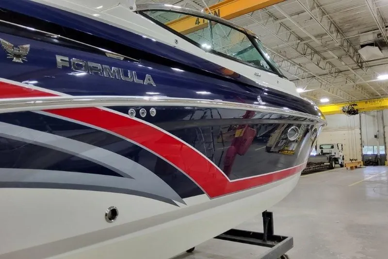 Slide: The Image of 2016 Formula 330 Crossover Bowrider interior with white seating and cup holders. - 31