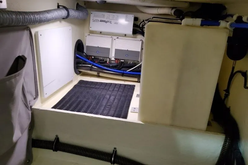 Slide: The Image of 2016 Formula 330 Crossover Bowrider cabin with white leather seating and wooden accents. - 38