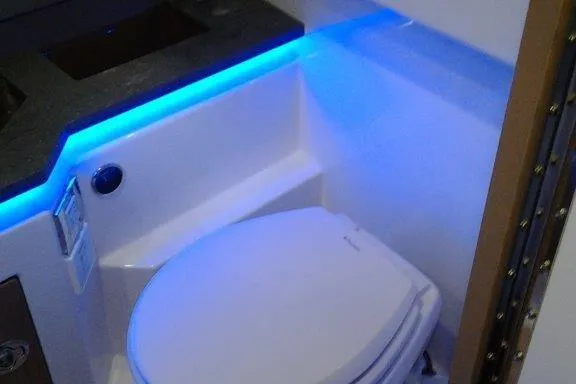 Slide: The Image of 2016 Formula 330 Crossover Bowrider, white leather seating, outdoor setting. - 7