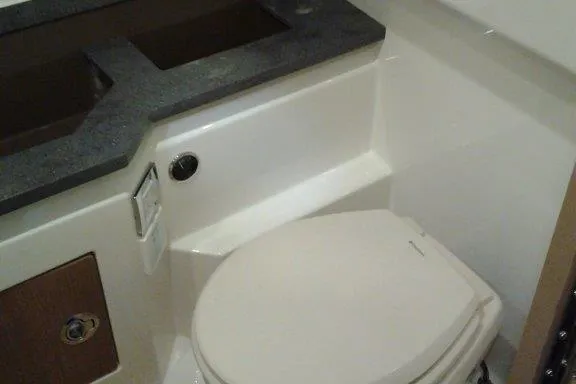 Slide: The Image of 2016 Formula 330 Crossover Bowrider interior with white seating and cup holders. - 8