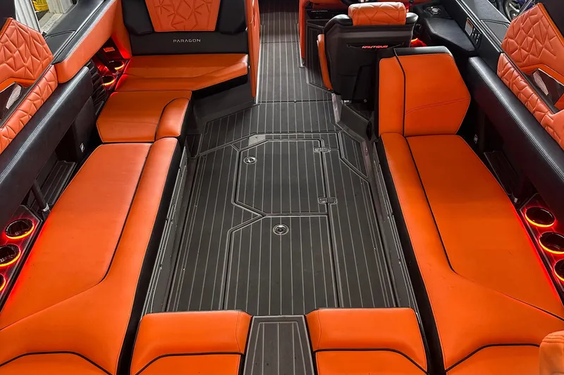 Slide: The Image of 2022 Nautique Super Air Nautique G25 Paragon interior with orange seating and ambient lighting. - 3