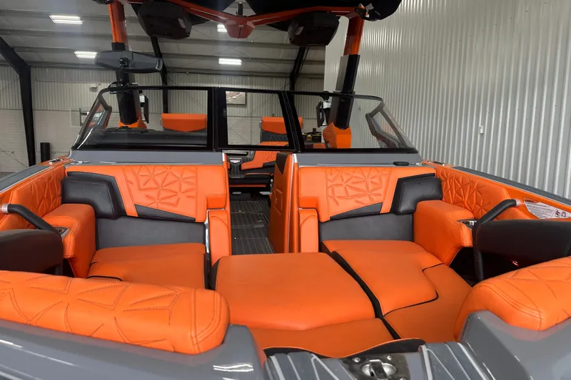 Slide: The Image of 2022 Nautique Super Air Nautique G25 Paragon interior with orange and gray seating. - 4