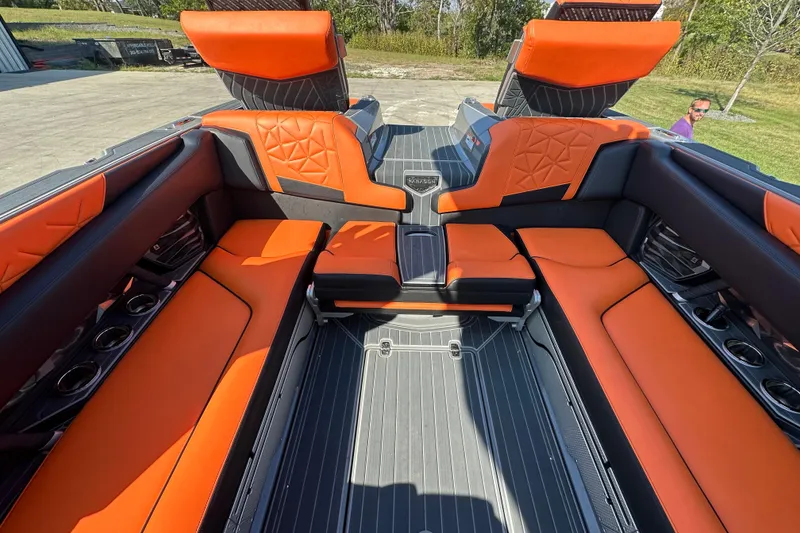 Slide: The Image of 2022 Nautique Super Air Nautique G25 Paragon interior with orange and black seating. - 5