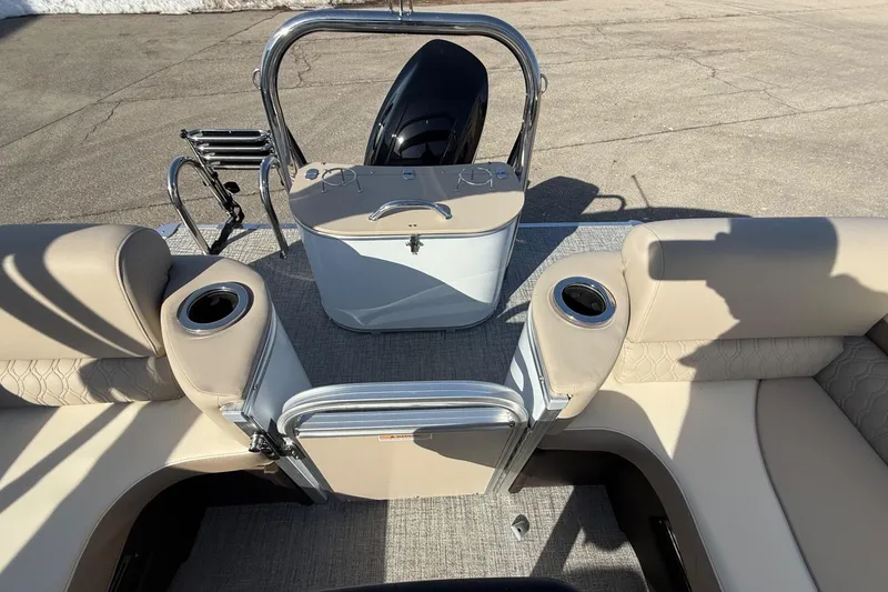 Slide: The Image of 2025 Tahoe 2385 boat interior with beige seating and cup holders. - 12