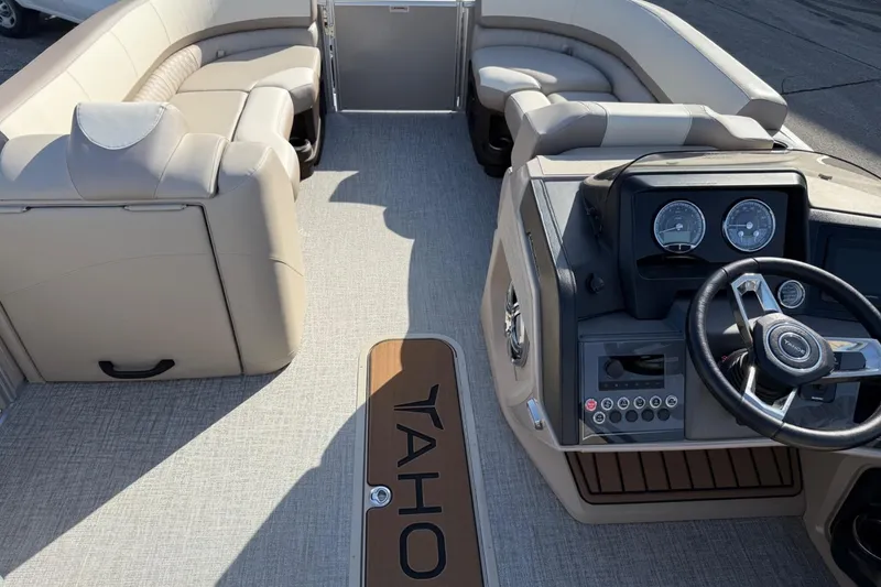 Slide: The Image of 2025 Tahoe 2385 boat interior with beige seating and modern dashboard. - 14