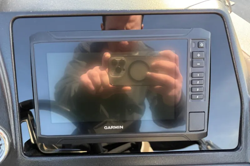 Slide: The Image of Garmin display on 2025 Tahoe 2385 dashboard, reflecting a person taking a photo. - 19