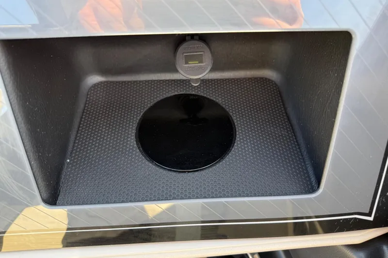 Slide: The Image of 2025 Tahoe 2385 storage compartment with USB port and textured surface. - 20