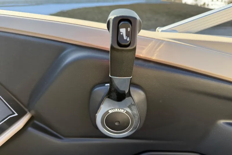 Slide: The Image of Throttle control lever on a 2025 Tahoe 2385 boat, featuring Suzuki branding. - 21