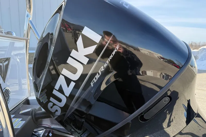 Slide: The Image of Suzuki four-stroke engine on 2025 Tahoe 2385 boat, reflecting outdoor scene. - 5