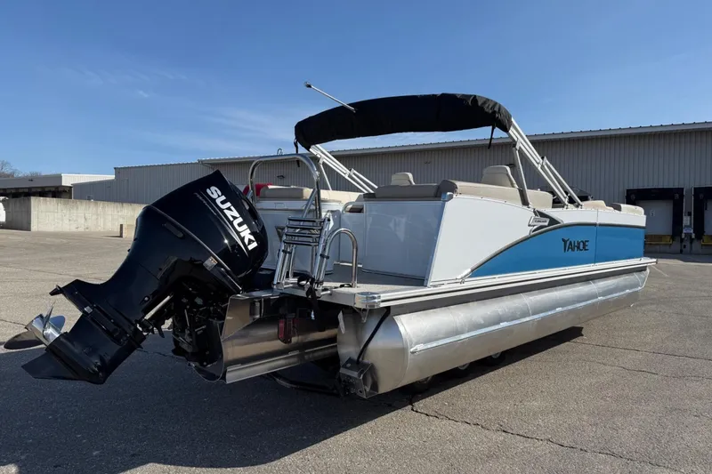 Slide: The Image of 2025 Tahoe 2385 pontoon boat with Suzuki outboard motor, parked outdoors. - 7