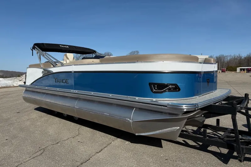 Slide: The Image of 2025 Tahoe 2385 pontoon boat with blue and white exterior on a trailer. - 9