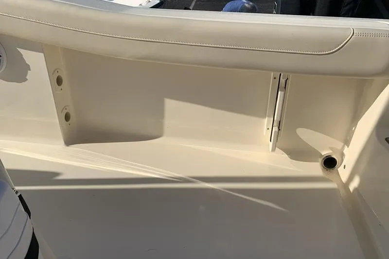 Slide: The Image of 2026 Scout 215 XSF boat interior detail with seating and storage area. - 15