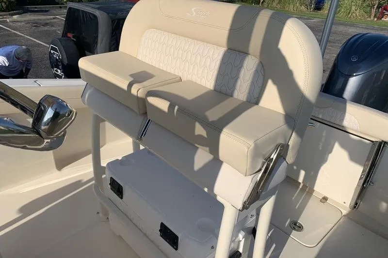 Slide: The Image of 2026 Scout 215 XSF boat interior with beige seating and storage compartment. - 17