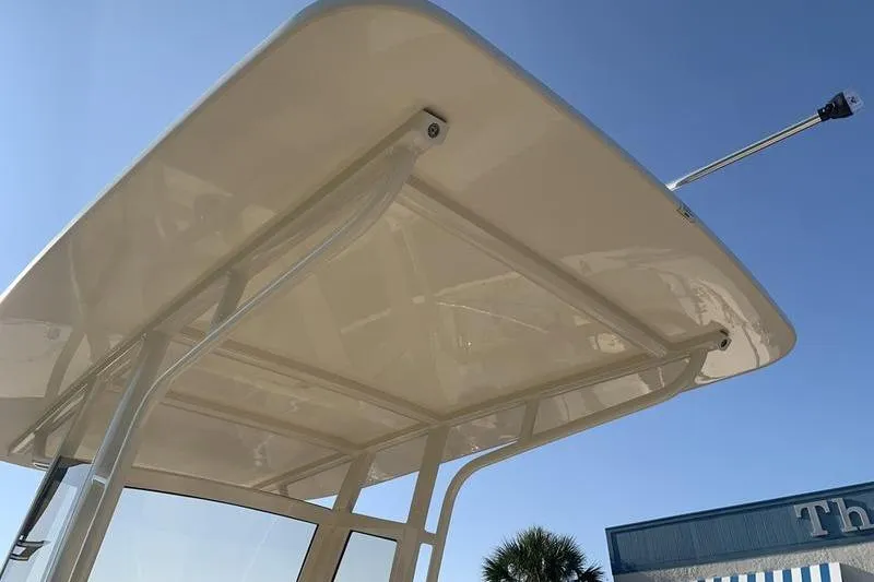 Slide: The Image of 2026 Scout 215 XSF boat canopy under clear blue sky. - 19