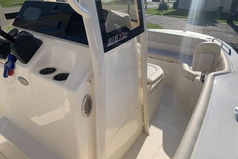 Slide: The Image of 2026 Scout 215 XSF boat interior with steering console and seating area. - 24