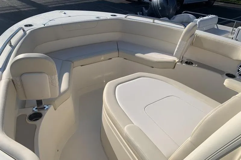 Slide: The Image of 2026 Scout 215 XSF boat interior with beige seating and cup holders. - 28