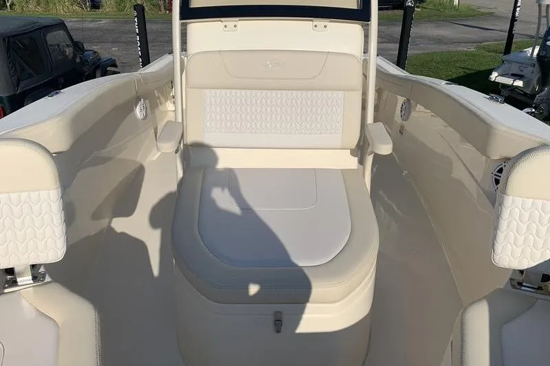 Slide: The Image of 2026 Scout 215 XSF boat interior with cushioned seating and armrests. - 29