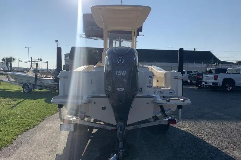 Slide: The Image of 2026 Scout 215 XSF boat with Yamaha 150 engine, parked outdoors. - 3