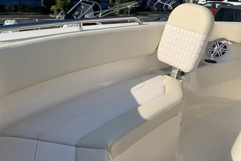 Slide: The Image of 2026 Scout 215 XSF boat interior with white seating and speaker detail. - 31