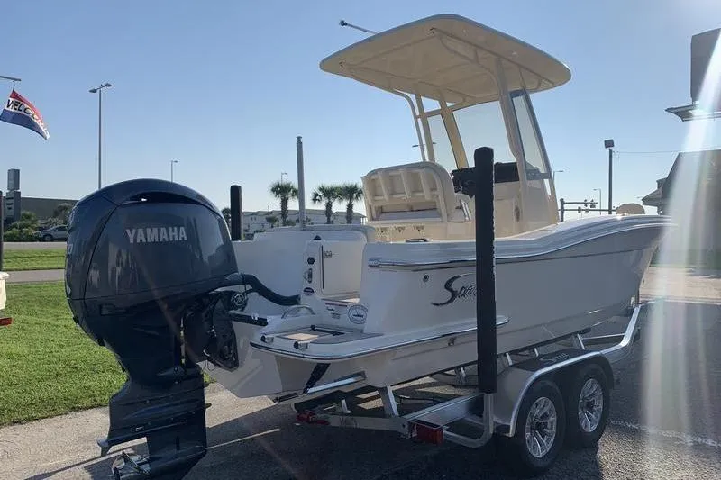 Slide: The Image of 2026 Scout 215 XSF boat on trailer with Yamaha outboard motor in sunny setting. - 4