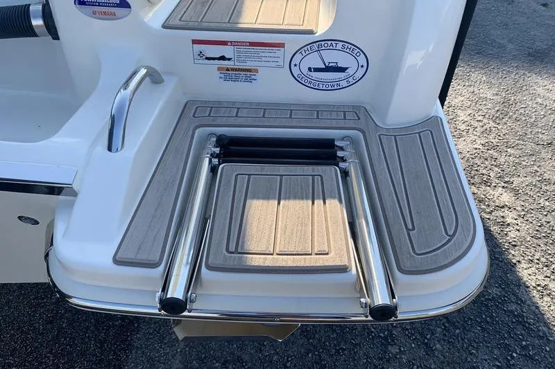 Slide: The Image of 2026 Scout 215 XSF boat swim platform with foldable ladder and safety warnings. - 9