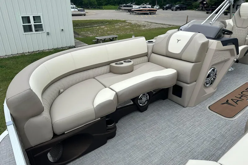 Slide: The Image of Luxurious seating on 2025 Tahoe 2385 boat, featuring beige upholstery and integrated cup holders. - 13