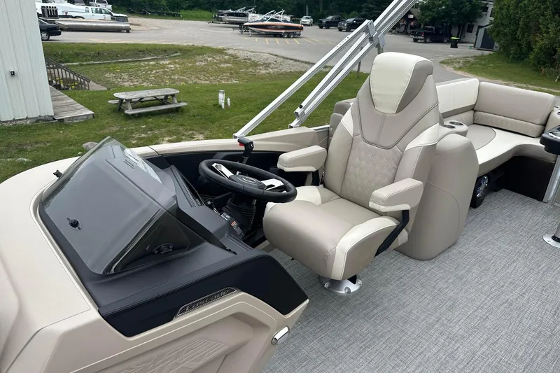 Slide: The Image of 2025 Tahoe 2385 boat interior with luxurious captain's chair and modern dashboard. - 19