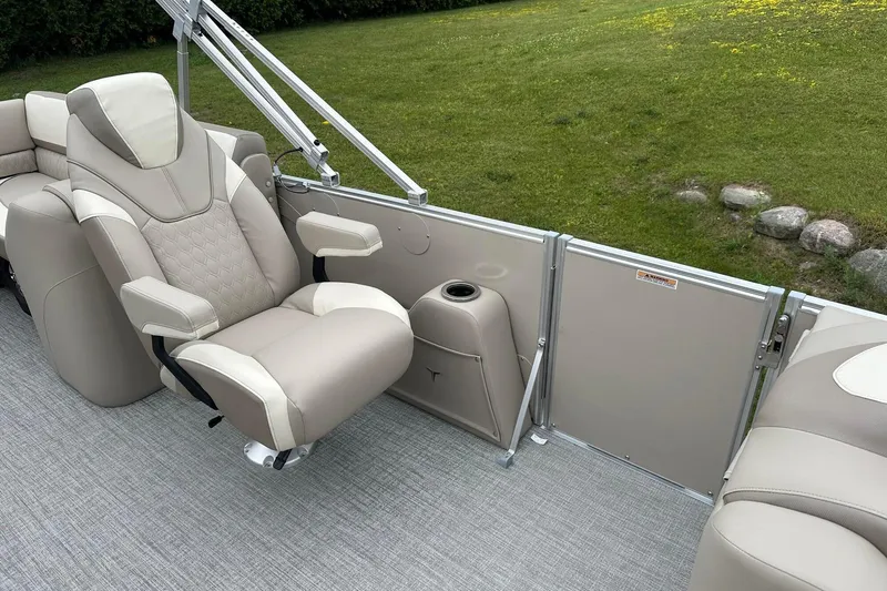 Slide: The Image of Luxurious seating on 2025 Tahoe 2385 boat, featuring beige upholstery and cup holder. - 20