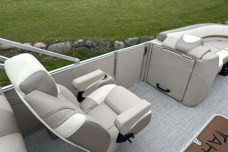 Slide: The Image of Luxurious seating on 2025 Tahoe 2385 pontoon boat, featuring beige upholstery and armrests. - 22