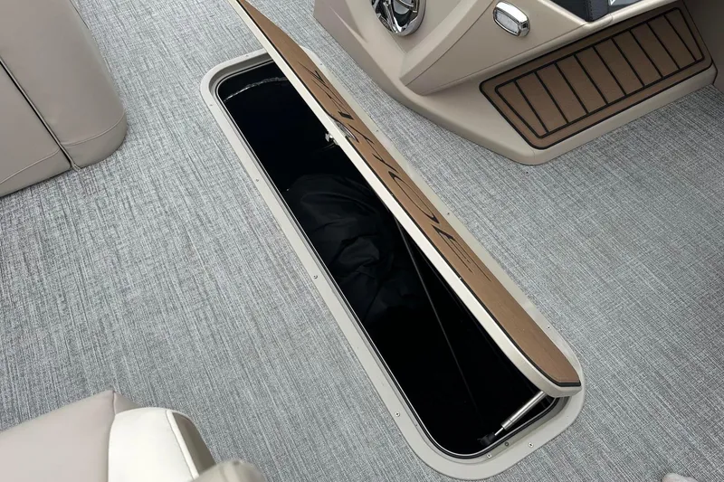 Slide: The Image of Open storage compartment on 2025 Tahoe 2385 boat with sleek interior design. - 24