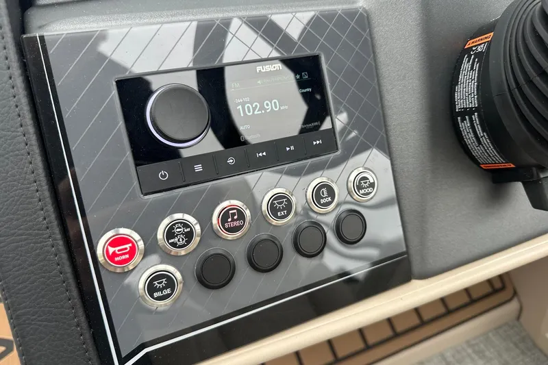 Slide: The Image of Control panel of 2025 Tahoe 2385 with radio and function buttons. - 25