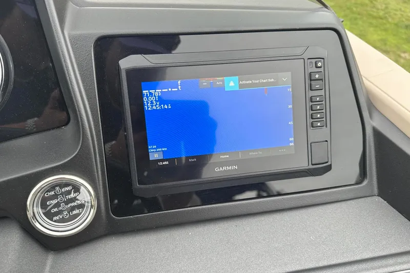 Slide: The Image of Garmin display on 2025 Tahoe 2385 boat dashboard, showing navigation and engine controls. - 27