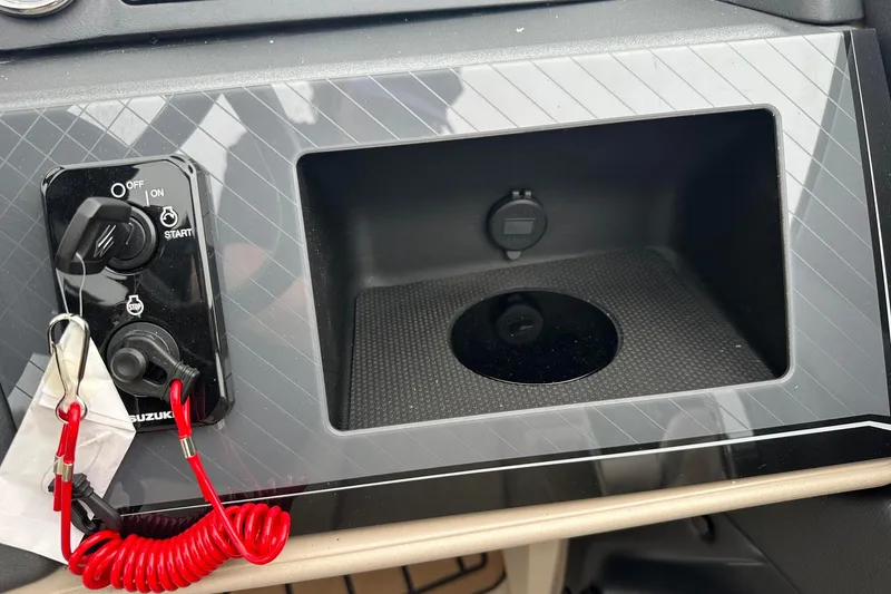 Slide: The Image of Control panel of 2025 Tahoe 2385 with ignition switch and storage compartment. - 28