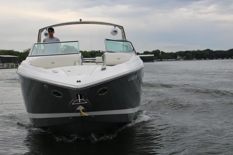 Slide: The Image of 2021 Cobalt R35 Surf boat cruising on a lake under cloudy skies. - 12