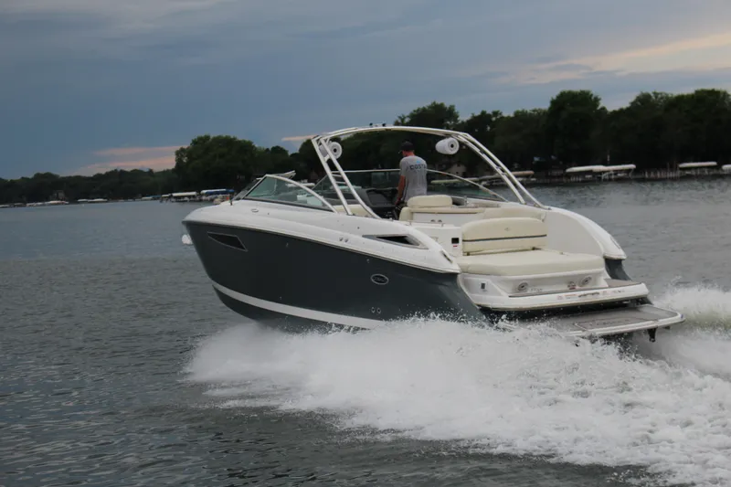 Slide: The Image of 2021 Cobalt R35 Surf boat cruising on a lake with scenic background. - 16