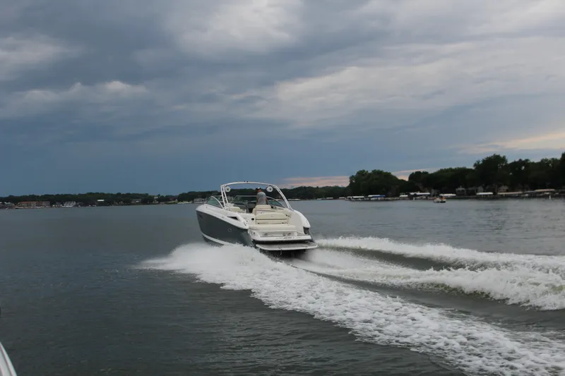 Slide: The Image of 2021 Cobalt R35 Surf boat cruising on a lake under cloudy skies. - 17